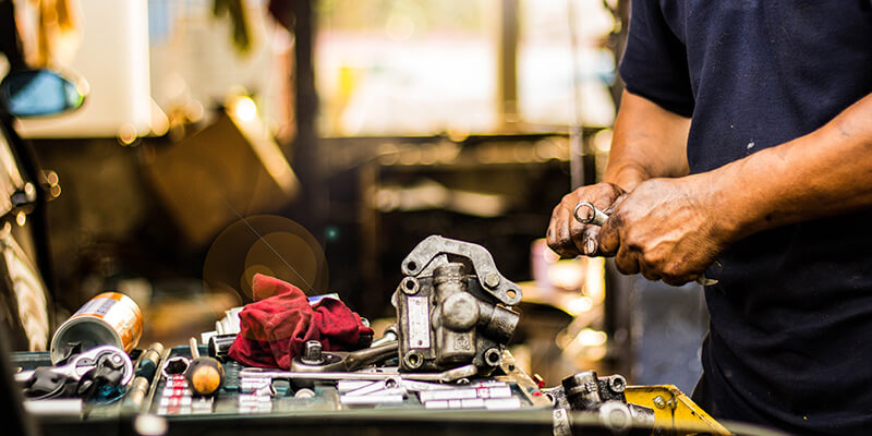 mechanic with car parts