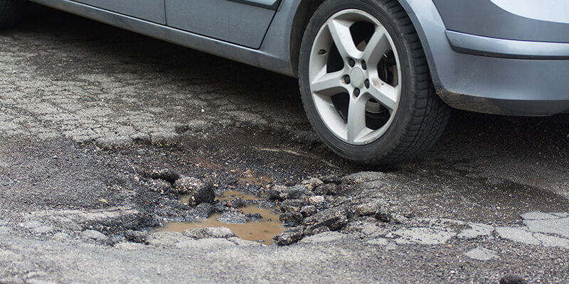 Car near pothole